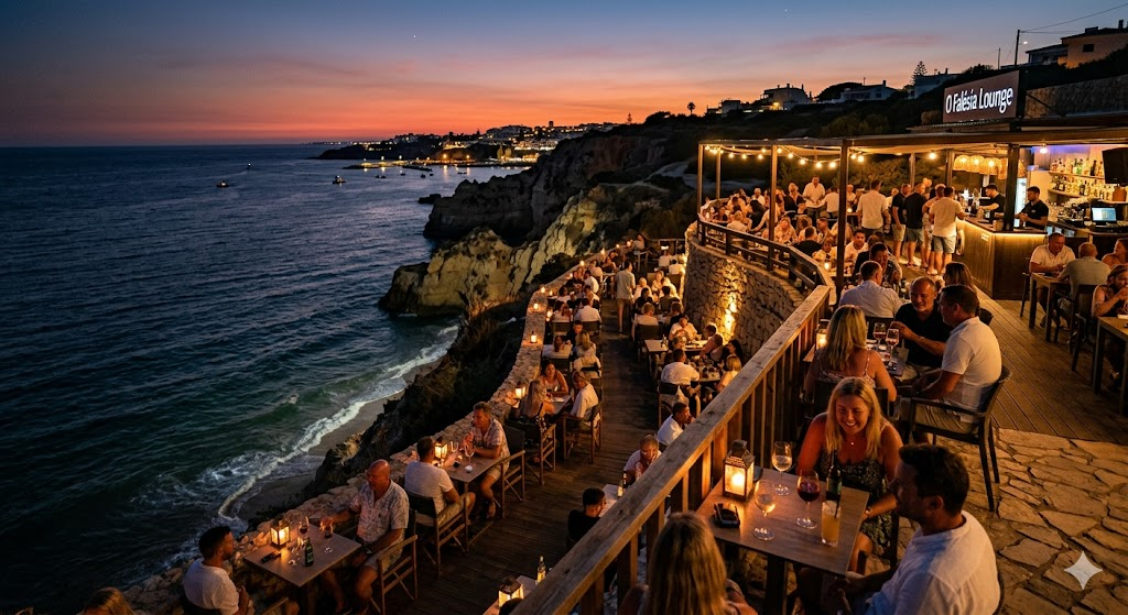 A scenic evening shot of a lively outdoor cliffside lounge in the Algarve, Portugal, overlooking the illuminated Atlantic ocean with patrons enjoying drinks at twilight.